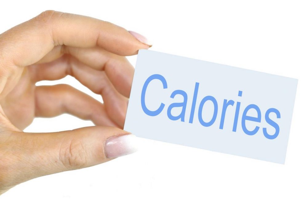 Someone holding a card that reads calories. 
